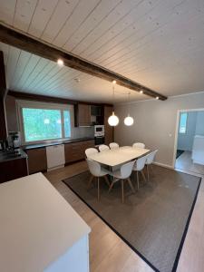 a kitchen and dining room with a table and chairs at Apartment Aurora in Rovaniemi