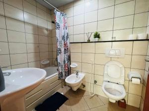 a bathroom with a sink and a toilet and a tub at skynest holiday homes 1bedroom apartment 4003 in Dubai