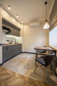 a kitchen with a table and chairs in a room at Idea Design Apart-Hotel Prorizna in Kyiv