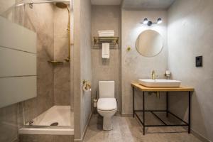 a bathroom with a toilet and a sink and a shower at Idea Design Apart-Hotel Prorizna in Kyiv