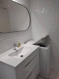 a white bathroom with a sink and a mirror at Charming 1 Bedroom Apartment in Puerto de Mogn in Puerto de Mogán +17 photos