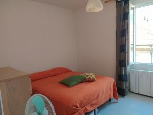 a bedroom with a bed with orange sheets and a window at MARE,BIKING, CLIMBING in Finale Ligure