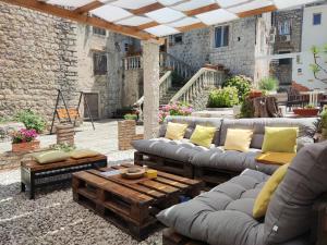 a patio with couches and a coffee table at Guest House Klaudija in Trogir