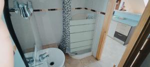 a small bathroom with a shower and a toilet at Apartamento Premium Relax C in Bárcena de Cicero +34 photos