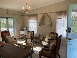 a living room with chairs and a table at The Karoo Moon House & Cottage in Barrydale