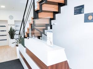 a spiral staircase in a living room with wood at Klaster SeaView Hotel in Chornomorsk