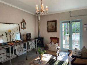 a living room with a mirror and a chandelier at The Karoo Moon House & Cottage in Barrydale