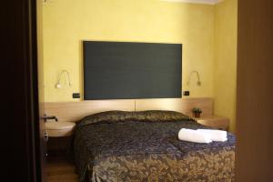 A bed or beds in a room at Suite - La Casa del Maestro