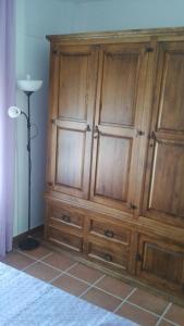 a large wooden cabinet in a room with a lamp at Apartamento Antonia 2 in Agua Amarga