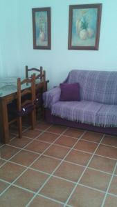 a living room with a couch and a table at Apartamento Antonia 2 in Agua Amarga