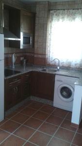 a kitchen with a sink and a washing machine at Apartamento Antonia 2 in Agua Amarga