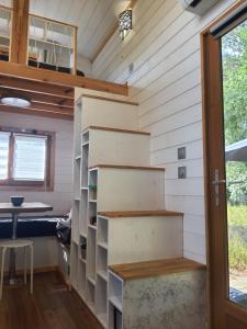 a tiny house with a staircase and a desk at Domaine Pinsol in Uchacq-et-Parentis