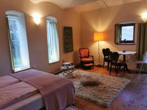 a bedroom with a bed and a table and chairs at Haus Garten der Seele in Neusiedl bei Güssing