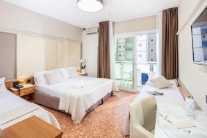Posteľ alebo postele v izbe v ubytovaní Hotel Royal