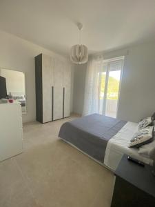a bedroom with a large bed and a window at Carlino's Home in Salerno