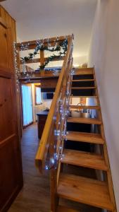 a wooden stairs with lights on them in a room at La Casa Degli Artisti - presso Sussy Residence in Falcade