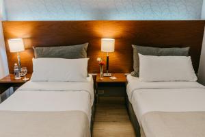Ένα ή περισσότερα κρεβάτια σε δωμάτιο στο Rochester Hotel Concept