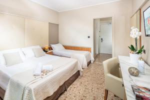 Posteľ alebo postele v izbe v ubytovaní Hotel Royal