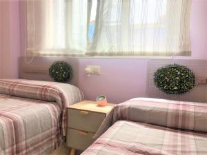 Łóżko lub łóżka w pokoju w obiekcie Magnífico Ático Dúplex con barbacoa