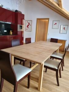 - une cuisine avec une table et des chaises en bois dans l'établissement Claudia 7 by SMR Rauris Apartments - inc Spa and National Summercard - near Gondola, à Rauris