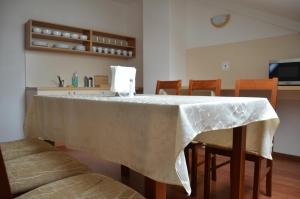 a table with a white table cloth on it at Penzion Bokros in Patince