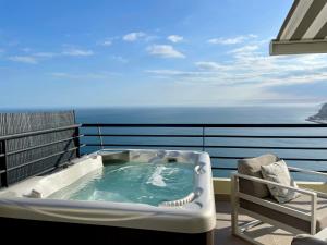 a hot tub on a balcony with the ocean at Sky & Sea in Sesimbra