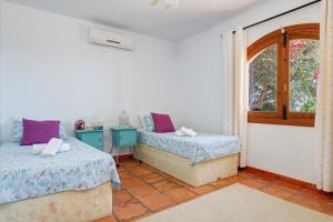 Postel nebo postele na pokoji v ubytování Villa Alicia
