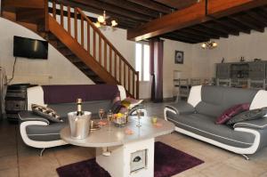 a living room with a couch and a table at La Boulonne in Festigny