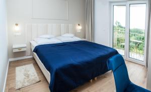 Säng eller sängar i ett rum på Jaśminowe Wzgórze Apartamenty blisko plaży