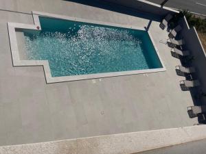 an overhead view of a swimming pool with water at Villa Madison in Posedarje