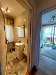 a bathroom with a toilet and a large window at Domek w Chochołowie in Chochołów +21 photos