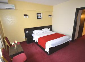 Säng eller sängar i ett rum på Hotel Ancor