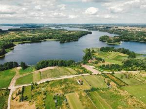 an aerial view of a river with trees at Fejny Dom - Jezioro Dadaj in Kromerowo