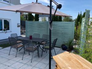 a table and chairs with an umbrella on a patio at Ferienwohnung Lipp in Waldstetten