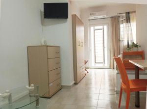 a living room with a dresser and a dining room at Studio Victory Chania in Chania