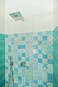 a bathroom with a shower with blue and white tiles at Sea Dream in Agropoli