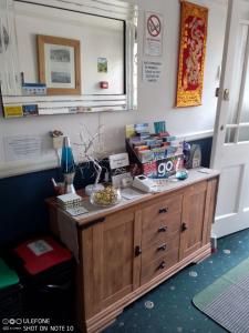 a room with a desk with books on it at Snowdon House Single rooms for solo travellers in Rhyl