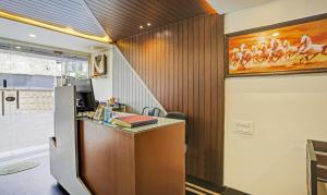 an office with a desk and a painting on the wall at Itsy Hotels Purple Suites in Bengaluru