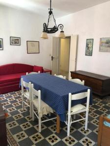 a living room with a blue table and chairs at Via Scappini in Rio Marina