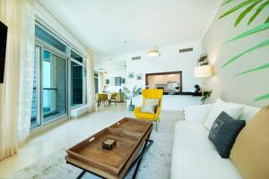 a living room with a couch and a coffee table at Maison Privee - 5 Star Apt with 2BR in Downtown Dubai in Dubai