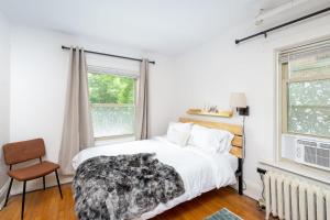 a white bedroom with a bed and a window at Flexhome Economy 1BR Apartment B4 - READ INFO in Milwaukee