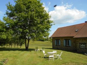 a group of chairs and a table in front of a house at Les Landes Gîte in Saint-Pardoux-Corbier +4 photos