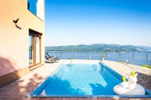 a swimming pool with a view of the water at Villa the View Zagore in Brseč