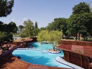 a large pool with a slide in a park at Hét Vezér Apartmanhotel in Komárom