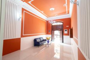 a living room with orange walls and a couch at Dream Palace in Bari