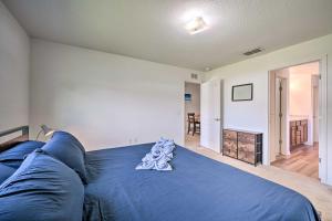 a blue bed in a room with a living room at Bright Cypress Gardens Home Near Legoland! in Cypress Gardens