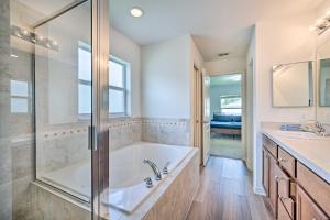 a bathroom with a tub and a shower and a sink at Bright Cypress Gardens Home Near Legoland! in Cypress Gardens +30 photos