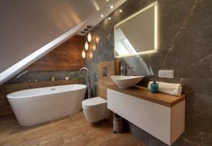 a bathroom with a sink and a toilet and a tub at Trevilles Art-Deco Józefina in Szklarska Poręba +13 photos