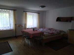 a bedroom with a bed and a table with chairs at Ubytování U Jarky in Český Krumlov