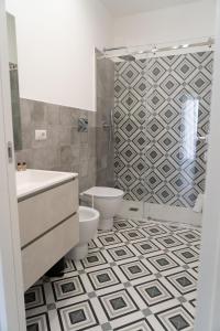 a bathroom with a toilet and a sink and a shower at Zagara e Lumia in Catania